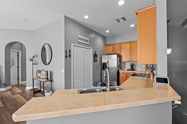 962 Ashworth Overlook Dr Unit C, Apopka, FL 32712 - kitchen with stainless steel fridge with ice dispenser, arched walkways, dark wood-style flooring, light countertops, and a peninsula