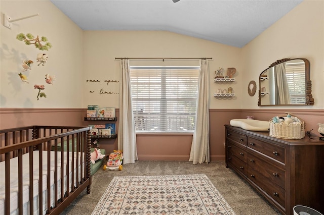 962 Ashworth Overlook Dr Unit C, Apopka, FL 32712 - bedroom featuring a nursery area, vaulted ceiling, multiple windows, carpet, and a wainscoted wall