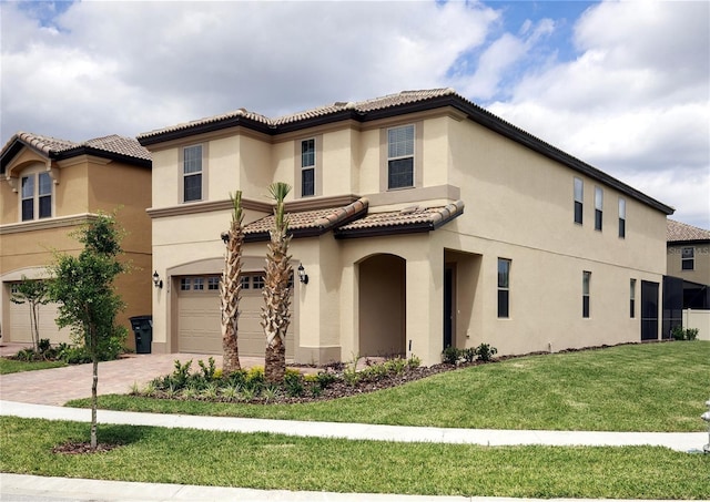8874 Qin Loop, Kissimmee, FL 34747 - mediterranean / spanish-style house featuring stucco siding, a garage, decorative driveway, a front lawn, and a tiled roof