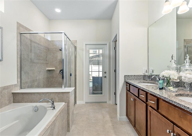 8874 Qin Loop, Kissimmee, FL 34747 - bathroom featuring a stall shower, a bath, double vanity, and tile patterned flooring