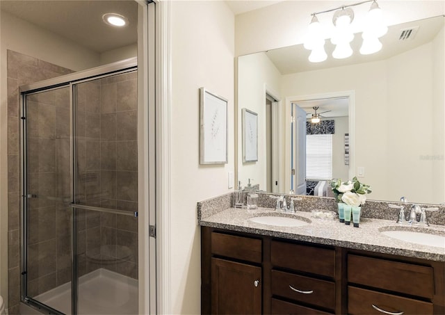8874 Qin Loop, Kissimmee, FL 34747 - ensuite bathroom featuring double vanity, a shower stall, and a chandelier