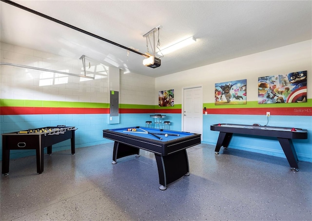 8874 Qin Loop, Kissimmee, FL 34747 - playroom with speckle patterned floor, electric panel, billiards, and concrete block wall