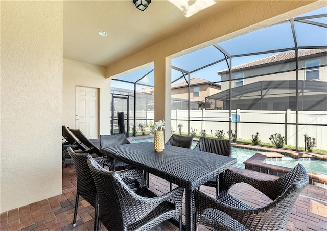 8874 Qin Loop, Kissimmee, FL 34747 - view of patio / terrace featuring a jacuzzi, a lanai, and outdoor dining space
