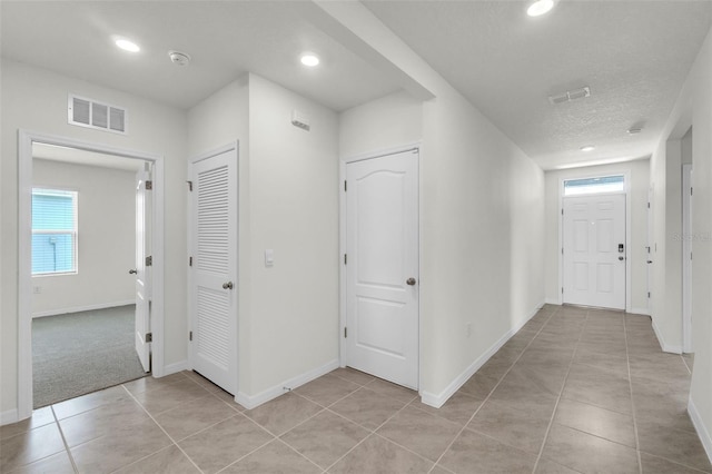 1850 Walnut Creek Dr, Kissimmee, FL 34744 - hall with recessed lighting and light tile patterned floors