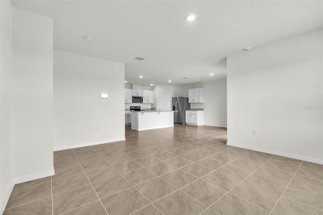 1850 Walnut Creek Dr, Kissimmee, FL 34744 - unfurnished living room featuring recessed lighting and light tile patterned floors