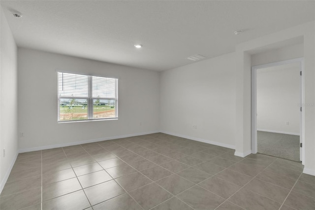 1850 Walnut Creek Dr, Kissimmee, FL 34744 - empty room with tile patterned floors and recessed lighting