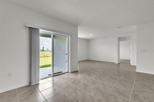 1850 Walnut Creek Dr, Kissimmee, FL 34744 - spare room featuring tile patterned floors and a textured ceiling
