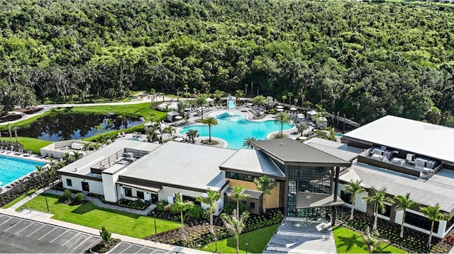 2661 Skyline Loop, Kissimmee, FL 34758 - drone / aerial view of a pool area and a heavily wooded area