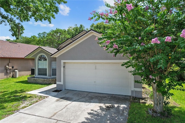 3388 Cypress Point Cir, Saint Cloud, FL 34772 - ranch-style house featuring stucco siding, driveway, a garage, a front yard, and roof with shingles