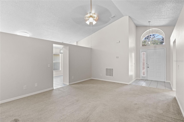 3388 Cypress Point Cir, Saint Cloud, FL 34772 - foyer entrance with a textured ceiling, light carpet, lofted ceiling, ceiling fan, and a chandelier