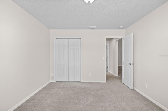 3388 Cypress Point Cir, Saint Cloud, FL 34772 - unfurnished bedroom with carpet, a textured ceiling, and a closet