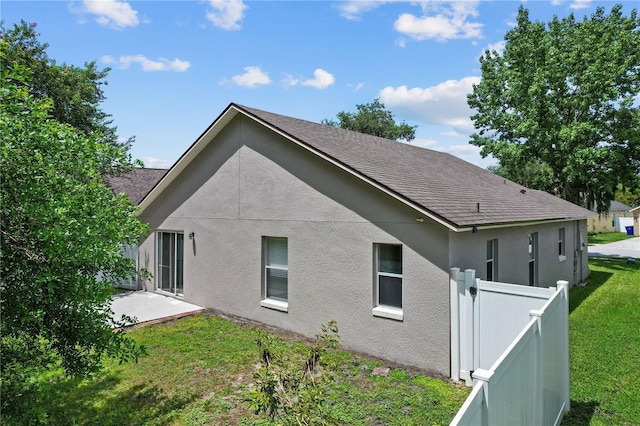 3388 Cypress Point Cir, Saint Cloud, FL 34772 - rear view of house with stucco siding, a shingled roof, and a patio