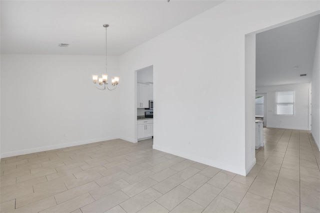 2912 SW Savona Blvd, Port St Lucie, FL 34953 - empty room with a chandelier and light tile patterned floors