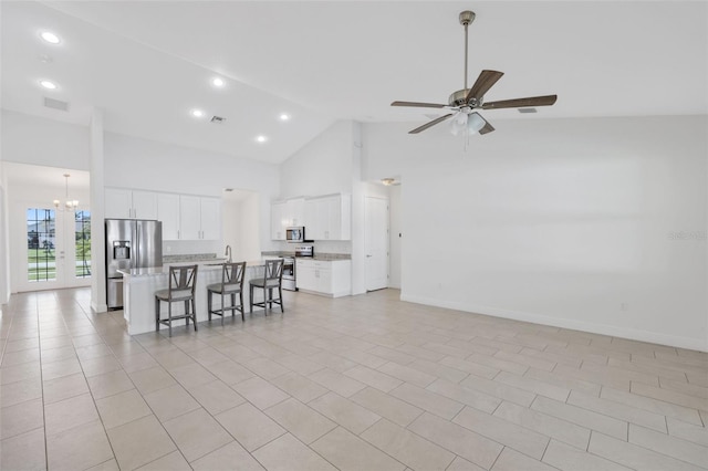 2912 SW Savona Blvd, Port St Lucie, FL 34953 - living room with high vaulted ceiling, a ceiling fan, a chandelier, recessed lighting, and light tile patterned floors