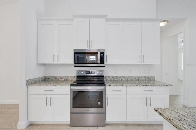 2912 SW Savona Blvd, Port St Lucie, FL 34953 - kitchen featuring stainless steel appliances, white cabinetry, and light stone counters