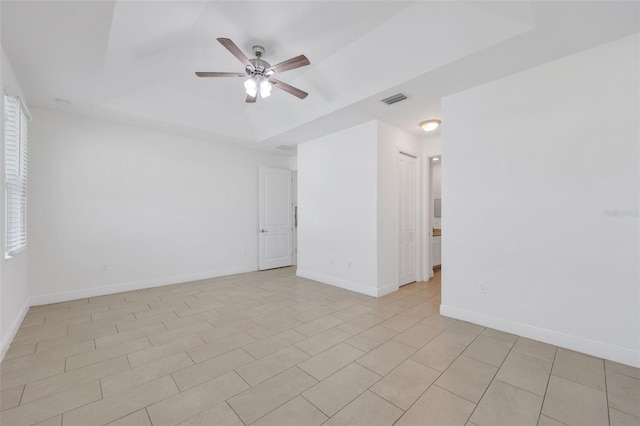 2912 SW Savona Blvd, Port St Lucie, FL 34953 - empty room with a raised ceiling, a ceiling fan, and light tile patterned floors