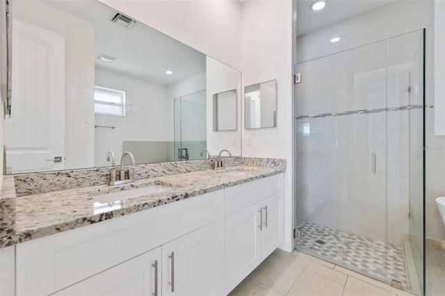 2912 SW Savona Blvd, Port St Lucie, FL 34953 - full bath with double vanity, a stall shower, recessed lighting, and tile patterned floors