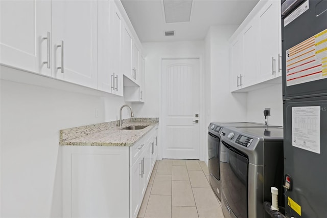 2912 SW Savona Blvd, Port St Lucie, FL 34953 - washroom with separate washer and dryer, a heating unit, light tile patterned floors, and cabinet space