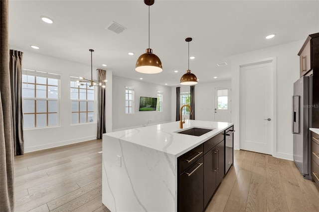 7412 Estuary Lake Loop, Celebration, FL 34747 - kitchen with stainless steel appliances, plenty of natural light, recessed lighting, light wood-style floors, and an island with sink