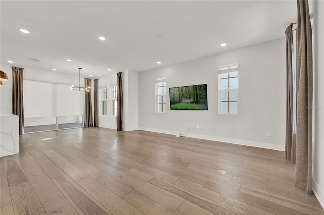 7412 Estuary Lake Loop, Celebration, FL 34747 - unfurnished living room featuring a chandelier, recessed lighting, and wood finished floors