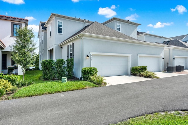 7412 Estuary Lake Loop, Celebration, FL 34747 - traditional home featuring a garage, stucco siding, driveway, and roof with shingles