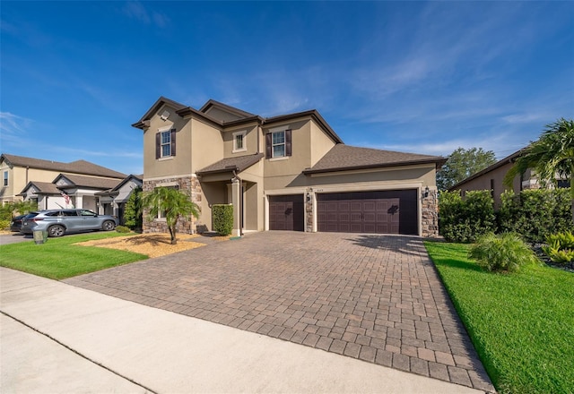 9379 Royal Estates Blvd, Orlando, FL 32836 - view of front facade with stone siding, stucco siding, decorative driveway, and a front yard