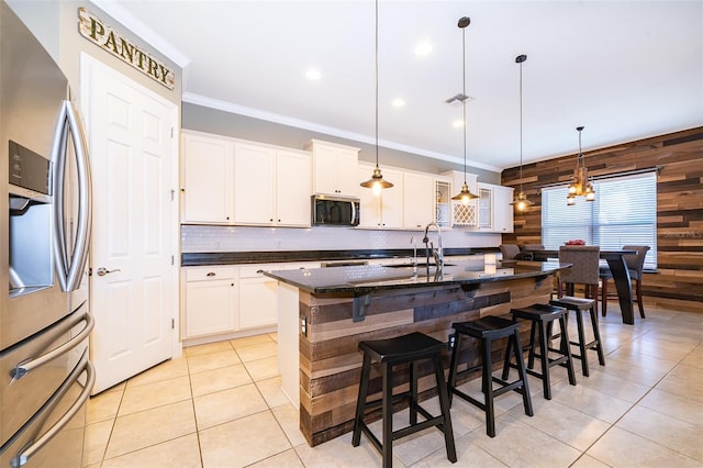 9379 Royal Estates Blvd, Orlando, FL 32836 - kitchen featuring stainless steel appliances, wood walls, light tile patterned floors, crown molding, and tasteful backsplash