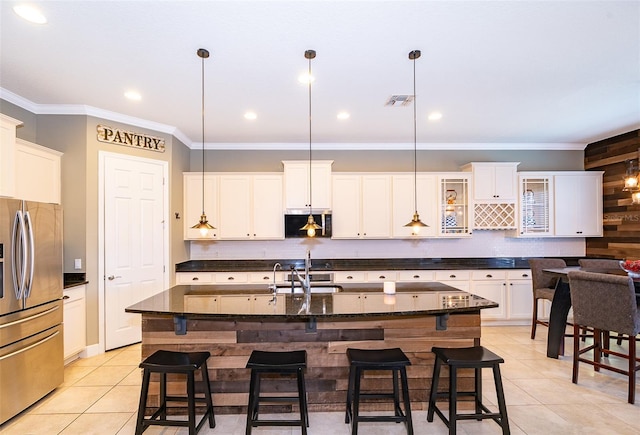 9379 Royal Estates Blvd, Orlando, FL 32836 - kitchen featuring appliances with stainless steel finishes, light tile patterned flooring, a kitchen breakfast bar, crown molding, and decorative light fixtures