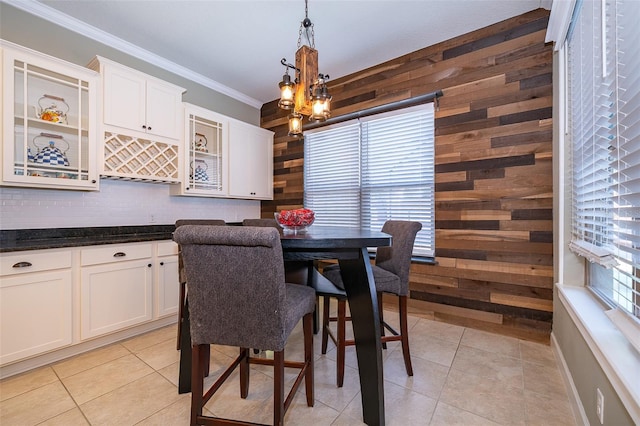 9379 Royal Estates Blvd, Orlando, FL 32836 - dining space with wood walls, crown molding, light tile patterned flooring, and a chandelier