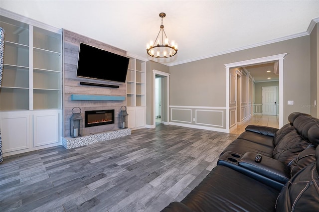 9379 Royal Estates Blvd, Orlando, FL 32836 - living room featuring ornamental molding, a decorative wall, a chandelier, a fireplace, and wood finished floors