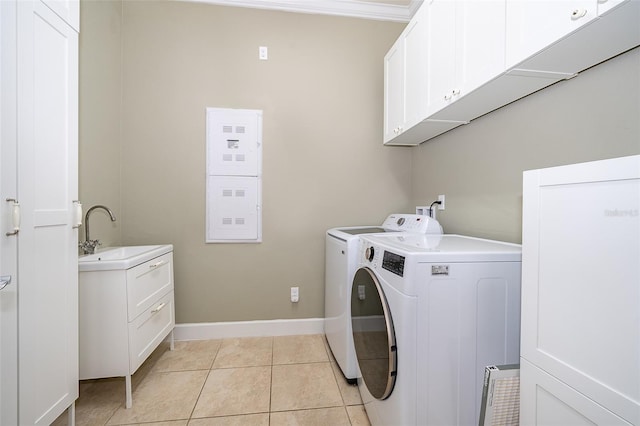 9379 Royal Estates Blvd, Orlando, FL 32836 - laundry area featuring independent washer and dryer, cabinet space, and light tile patterned flooring