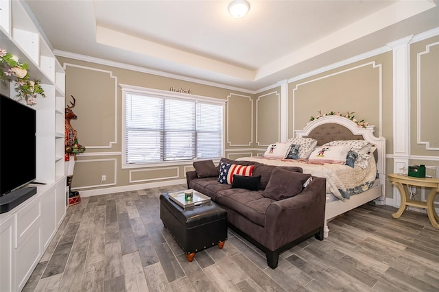 9379 Royal Estates Blvd, Orlando, FL 32836 - bedroom featuring a decorative wall, a raised ceiling, and wood finished floors