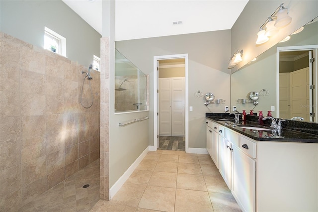 9379 Royal Estates Blvd, Orlando, FL 32836 - bathroom featuring a walk in shower, double vanity, a closet, and tile patterned floors