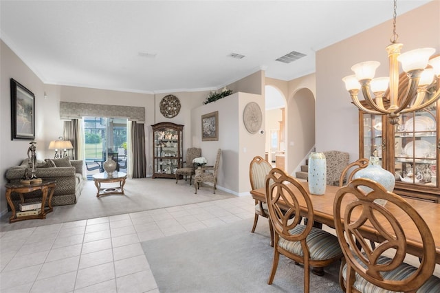 1331 Marble Crest Way, Winter Garden, FL 34787 - dining room featuring light tile patterned flooring, light carpet, stairway, arched walkways, and a chandelier