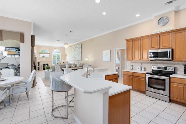 1331 Marble Crest Way, Winter Garden, FL 34787 - kitchen with appliances with stainless steel finishes, light tile patterned floors, light countertops, tasteful backsplash, and open floor plan