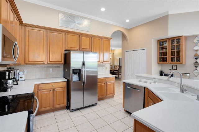 1331 Marble Crest Way, Winter Garden, FL 34787 - kitchen featuring appliances with stainless steel finishes, arched walkways, backsplash, crown molding, and light countertops