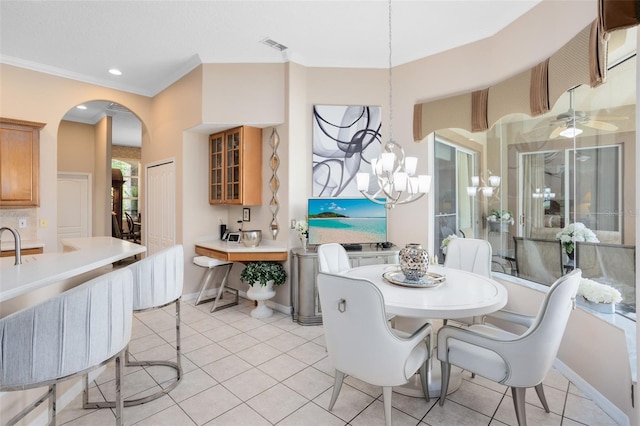 1331 Marble Crest Way, Winter Garden, FL 34787 - dining room featuring arched walkways, light tile patterned flooring, crown molding, and a chandelier