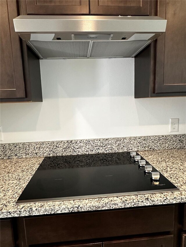14099 Lochend Way, Winter Garden, FL 34787 - kitchen with range hood, dark brown cabinets, and black electric cooktop