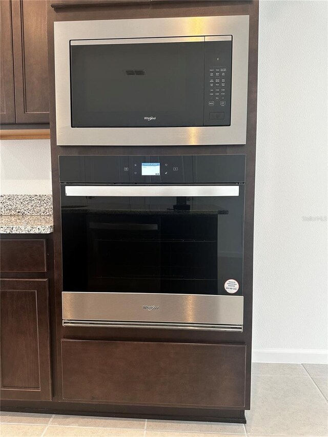 14099 Lochend Way, Winter Garden, FL 34787 - kitchen view of stainless steel appliances, dark brown cabinets, and light stone countertops