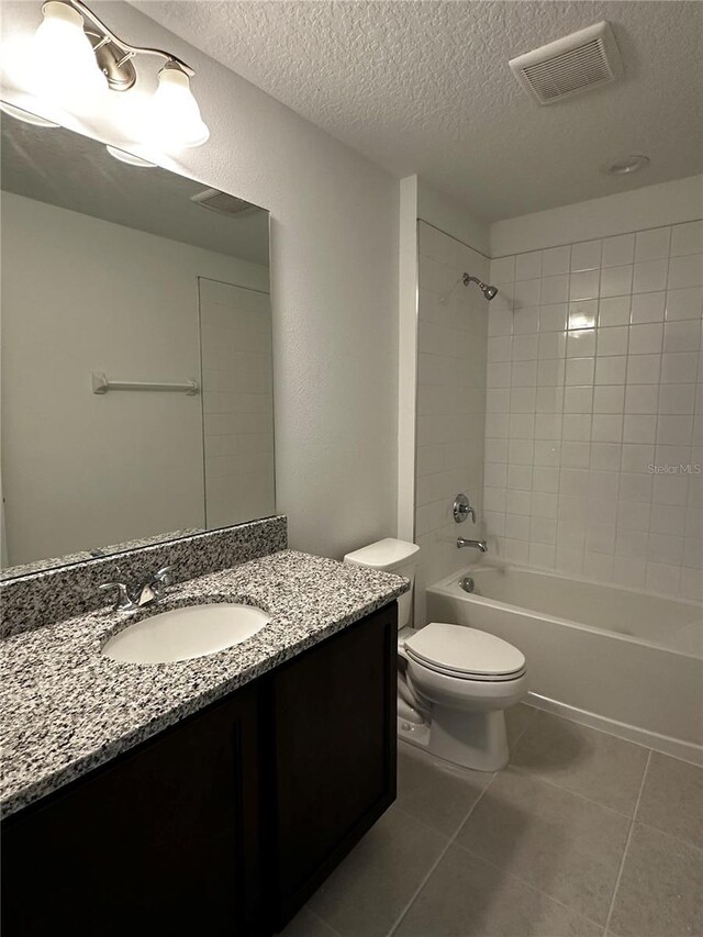 14099 Lochend Way, Winter Garden, FL 34787 - bathroom featuring tile patterned flooring, vanity, bathing tub / shower combination, and a textured ceiling
