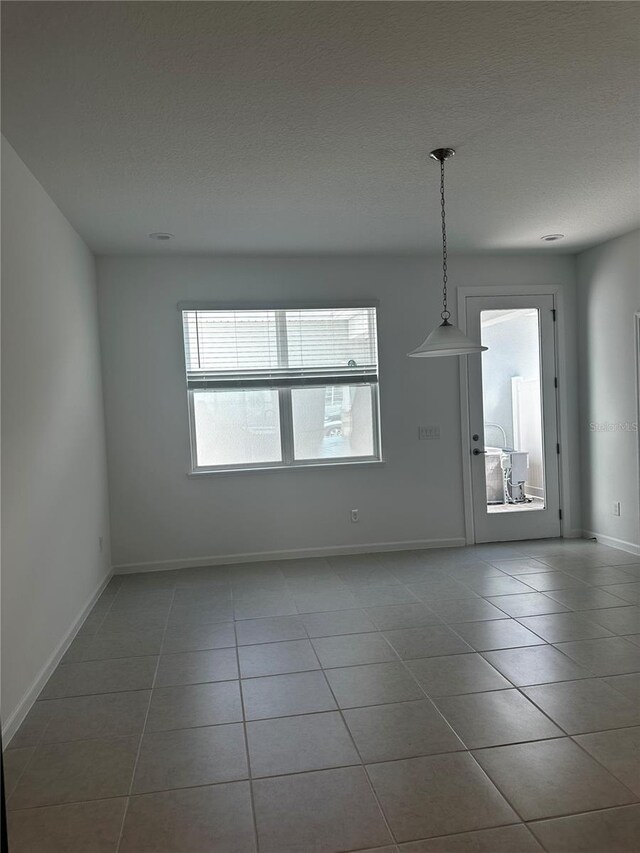 14099 Lochend Way, Winter Garden, FL 34787 - unfurnished dining area featuring tile patterned floors and a textured ceiling