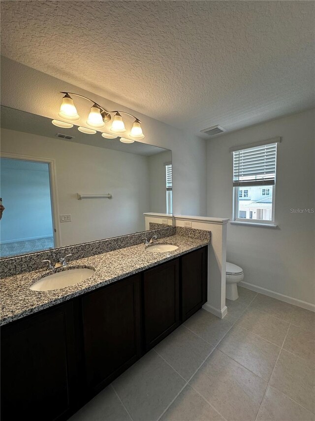 14099 Lochend Way, Winter Garden, FL 34787 - bathroom with double vanity, tile patterned flooring, and a textured ceiling