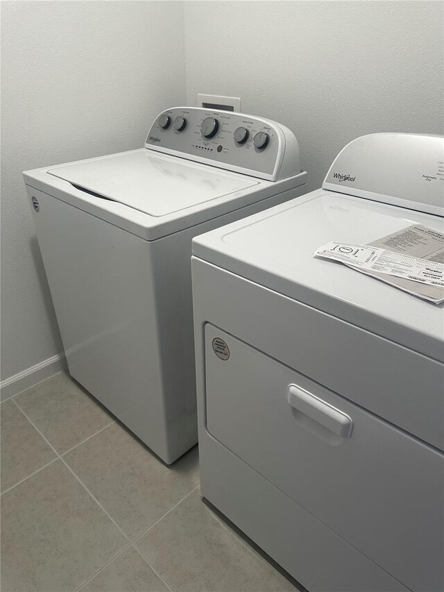 14099 Lochend Way, Winter Garden, FL 34787 - washroom featuring washer and clothes dryer and light tile patterned floors