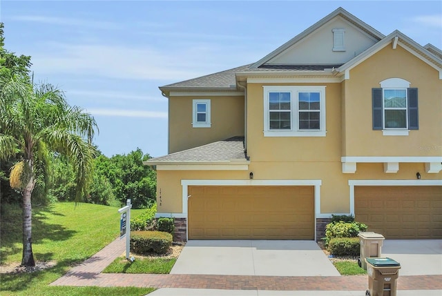 17458 Chateau Pine Way, Clermont, FL 34711 - view of front of home with concrete driveway, stucco siding, and a front lawn