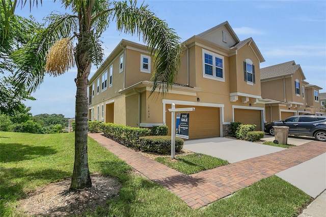 17458 Chateau Pine Way, Clermont, FL 34711 - view of front of home with driveway, a garage, stucco siding, a front lawn, and stone siding