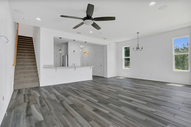 17458 Chateau Pine Way, Clermont, FL 34711 - unfurnished living room with dark wood-style flooring, plenty of natural light, a chandelier, and recessed lighting