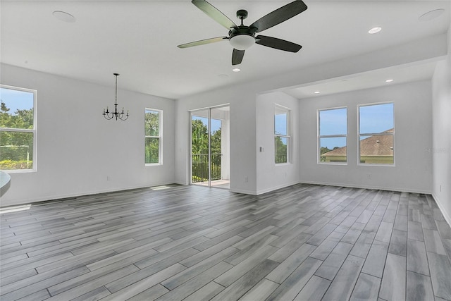 17458 Chateau Pine Way, Clermont, FL 34711 - unfurnished living room with wood finished floors, a chandelier, ceiling fan, and recessed lighting