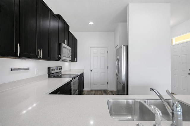17458 Chateau Pine Way, Clermont, FL 34711 - kitchen featuring stainless steel appliances, dark cabinets, light countertops, dark wood-style floors, and recessed lighting