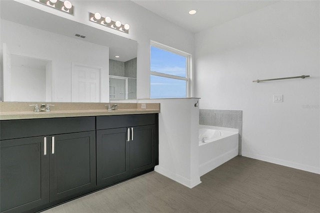 17458 Chateau Pine Way, Clermont, FL 34711 - full bath with double vanity, a shower stall, and a garden tub