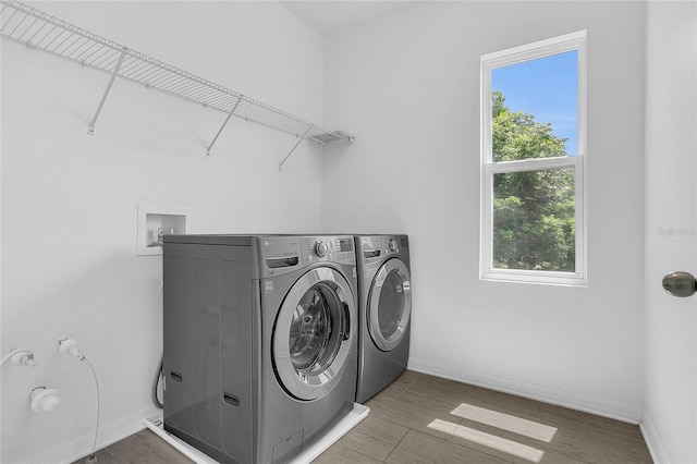17458 Chateau Pine Way, Clermont, FL 34711 - washroom featuring separate washer and dryer and wood finished floors